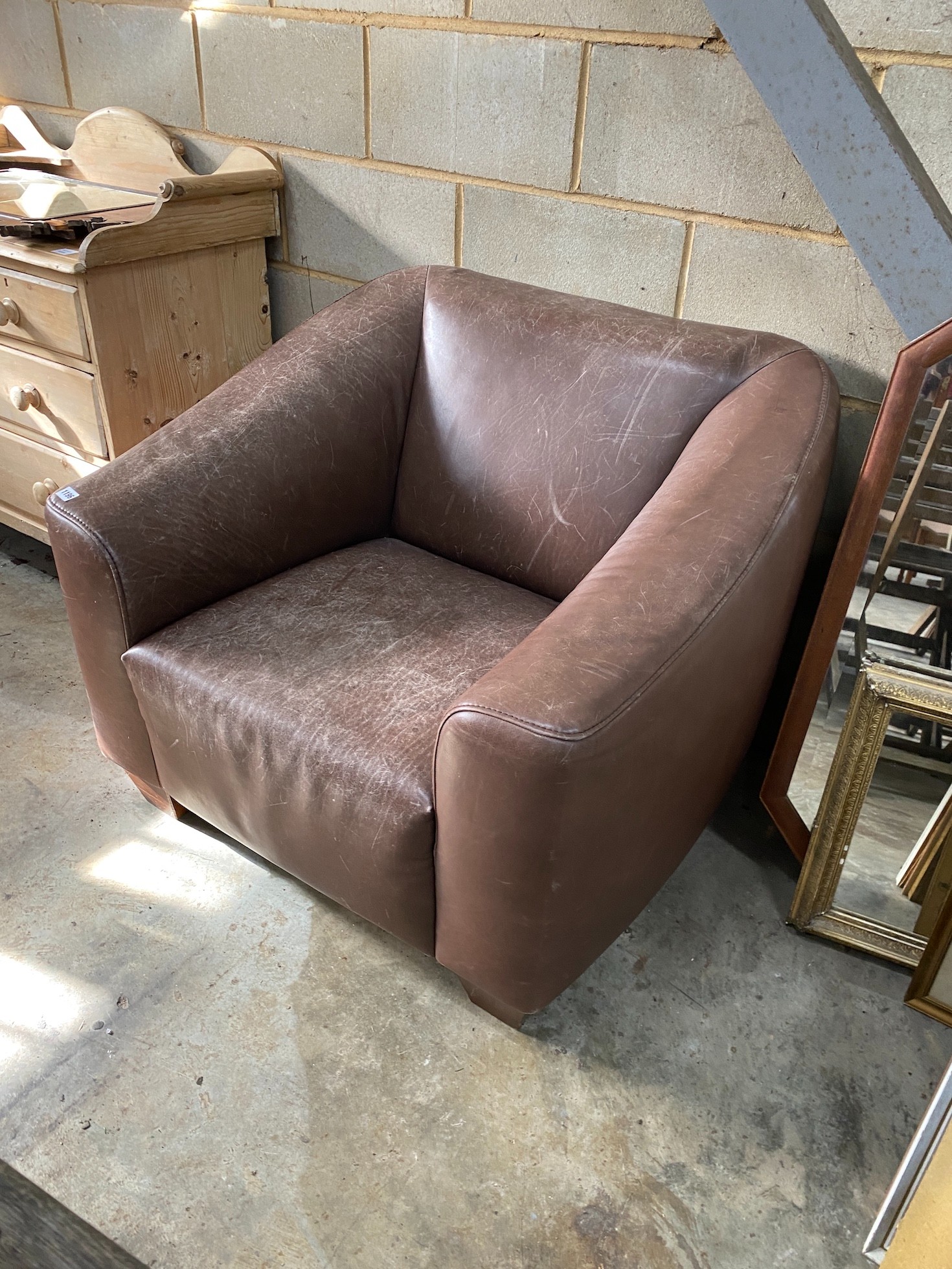 A Heals brown leather armchair, width 96cm, depth 84cm, height 78cm *Please note the sale commences at 9am.